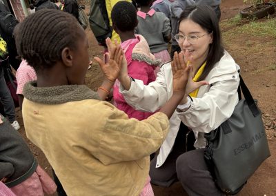 Image of a woman doing a high-five with a kid.